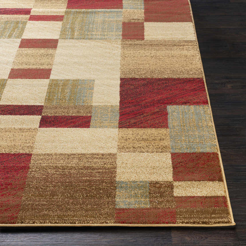 Close-up of the Maumee Brown Mosaic Performance Rug, featuring a geometric pattern in brown, red, beige, and green tones. Styleshot