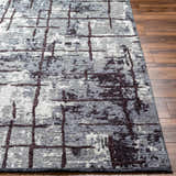 Close-up of the Mace Area Rug showing its charcoal, cream, and slate colors and contemporary grid pattern. Front