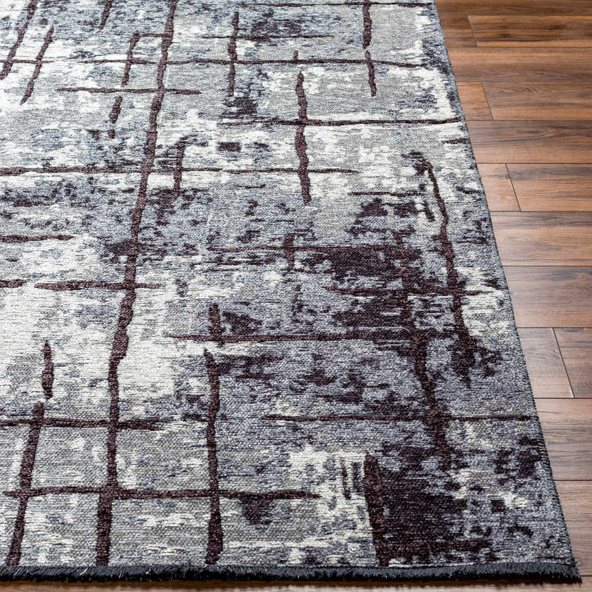 Close-up of the Mace Area Rug showing its charcoal, cream, and slate colors and contemporary grid pattern. Front