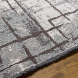 Close up of the Mace Area Rug showing charcoal lines on a cream and slate chenille-polyester blend. Texture
