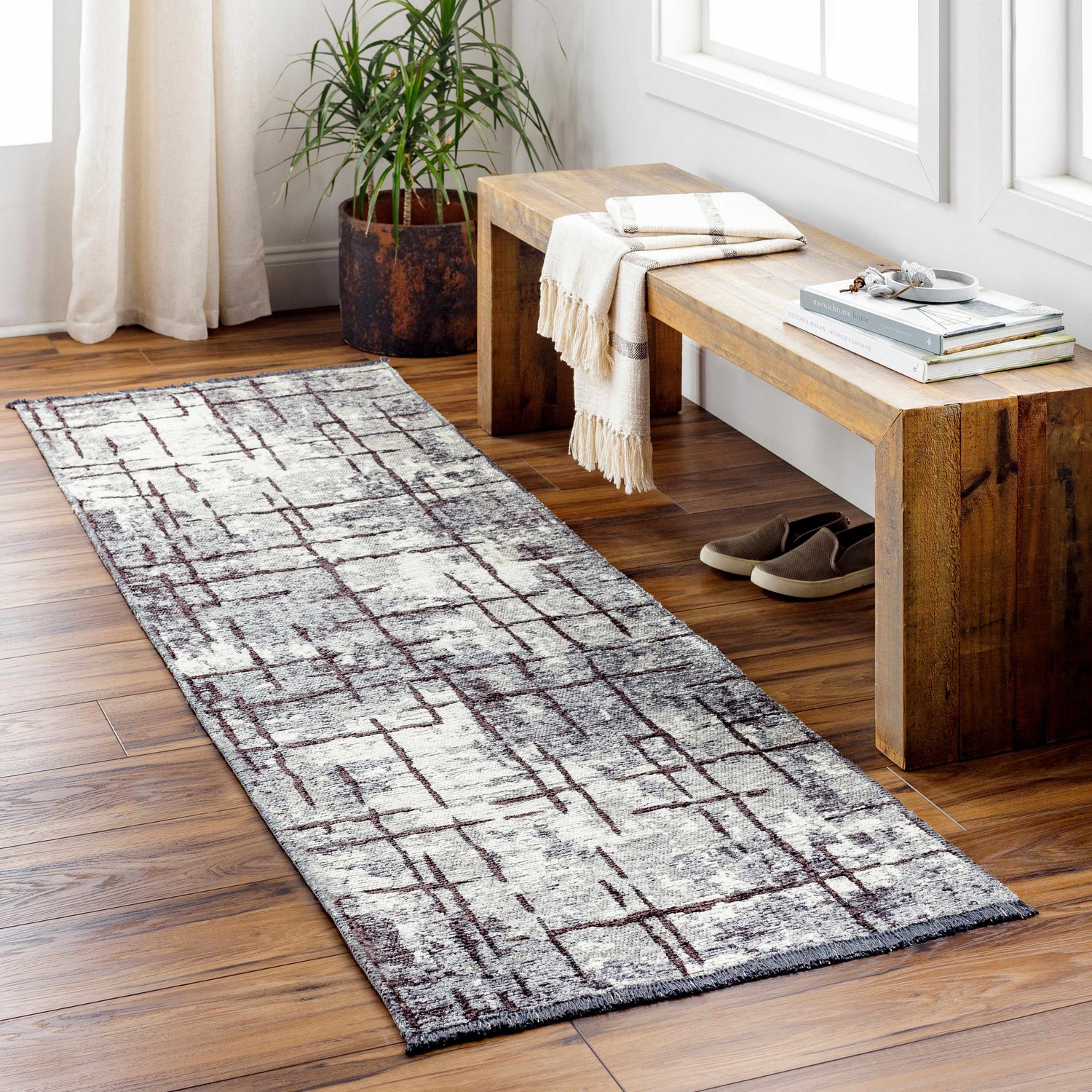 Entryway scene with a charcoal and cream Mace Area Rug runner, wood bench, and natural light. Roomscene-Runner