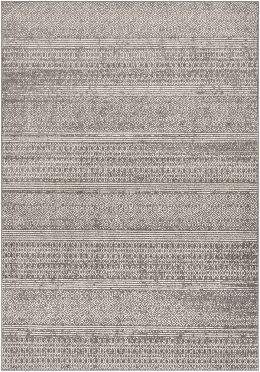 Close-up of the Mckinney Area Rug. Charcoal, light beige, and gray geometric pattern with a distressed, farmhouse style. Design-Rectangle-5373