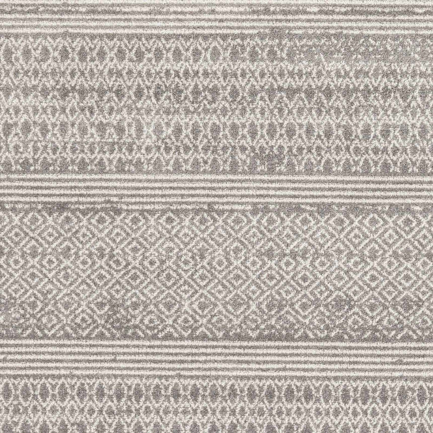 Close-up of Mckinney Area Rug. Charcoal, beige, and gray diamond and striped pattern. Machine woven texture. Swatch