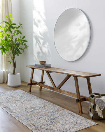 Entryway with a McKinlay Luxe Rug runner, wooden bench, round mirror, and potted plant. Roomscene-Runner