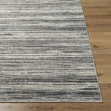 Close-up of Munya Area Rug showing charcoal, cream, and gray horizontal stripes on a wood floor. Southwestern style. Front