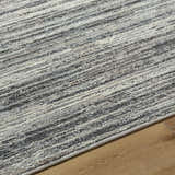Close-up of Munya Area Rug showing charcoal, cream, and gray Southwestern pattern and recycled PET yarn texture. Texture