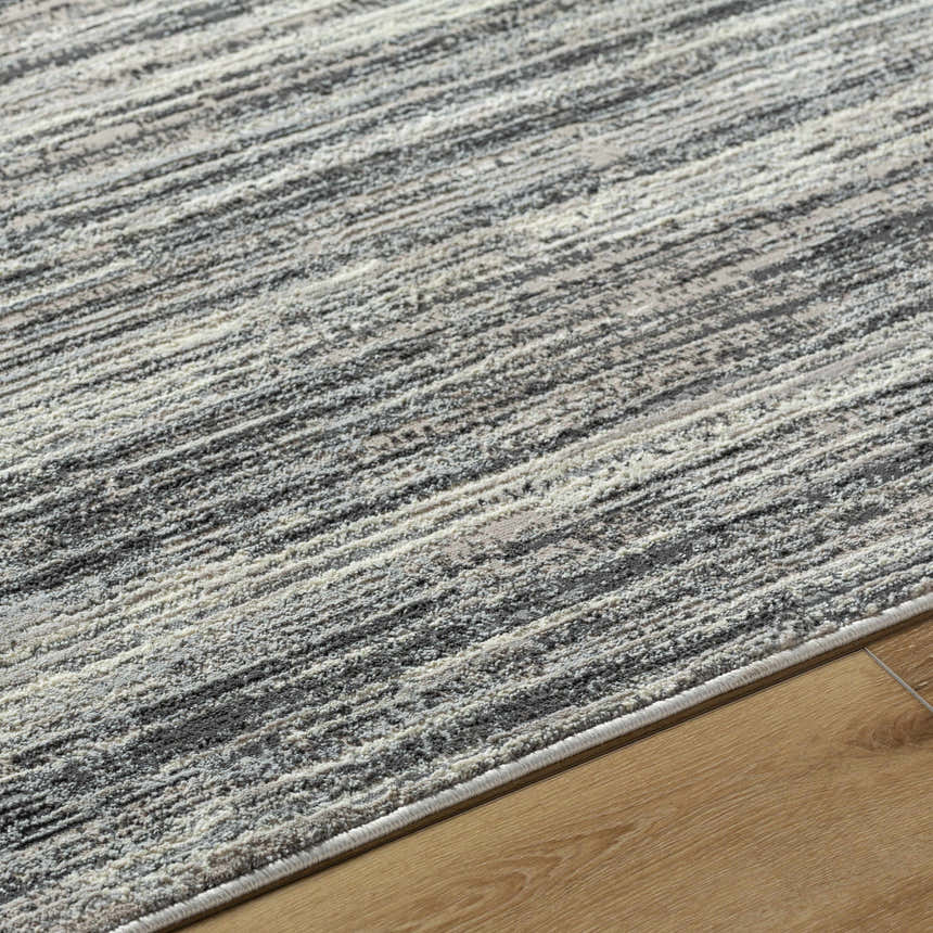Close-up of Munya Area Rug showing charcoal, cream, and gray Southwestern pattern and recycled PET yarn texture. Texture
