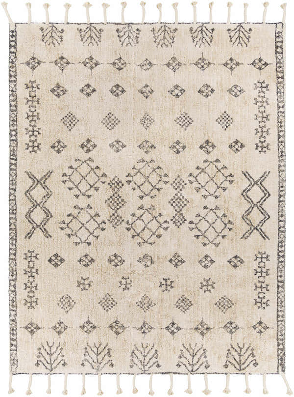 Close-up of the Mecca Area Rug. Cream cotton rug with charcoal bohemian-inspired geometric and tree pattern and tassels. Design-Rectangle-810