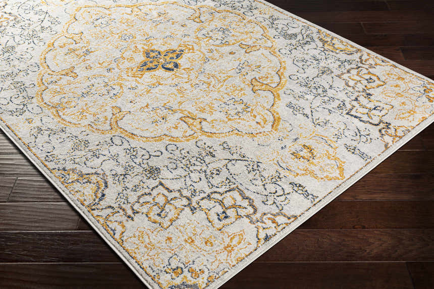 Close-up of the Mehoopany Area Rug featuring a traditional burnt orange and navy pattern on a light beige background. Corner