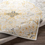 Close-up of the Mehoopany Area Rug showing its burnt orange, gray, and navy bohemian-inspired pattern and machine-woven texture. Fold