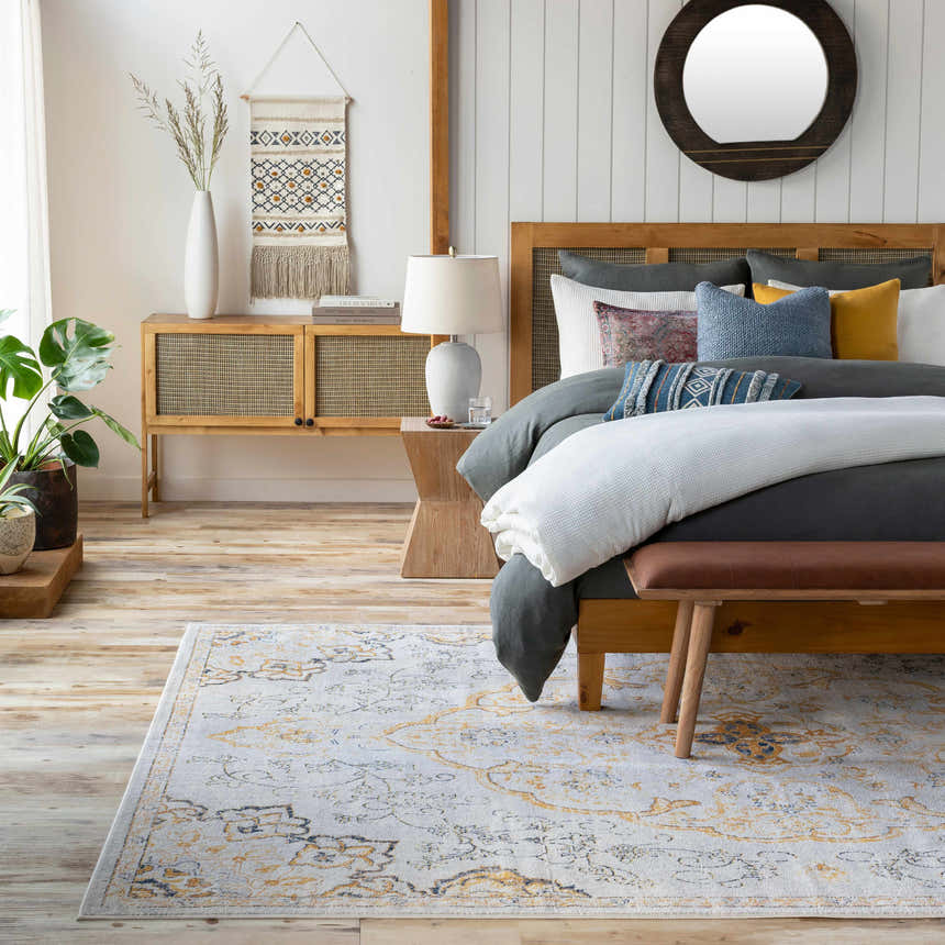 Bohemian bedroom scene with the Mehoopany Area Rug in burnt orange and gray, styled with a wooden bed and neutral decor. Roomscene-Rectangle