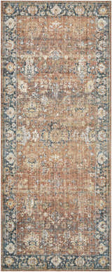 Close-up of the Mele Area Rug, a machine-woven rug in burnt orange, bone, and dark brown with a traditional floral pattern. Design-Runner