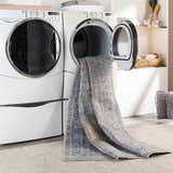 Mianay Washable Area Rug in laundry room being washed. Blue, beige oriental rug in dryer. Easy clean rugs. Washing-Machine
