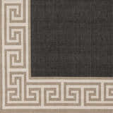 Close-up of the Michael Area Rug: a charcoal rug with a Greek key border in beige and white. Swatch