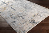 Close-up of the Midfield Luxe Rug showing its charcoal, cream, and gray contemporary design and soft polyester texture. Corner
