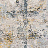 Close-up of the Midfield Luxe Rug. Contemporary design with charcoal, cream, and blue abstract patterns. Soft polyester texture. Swatch
