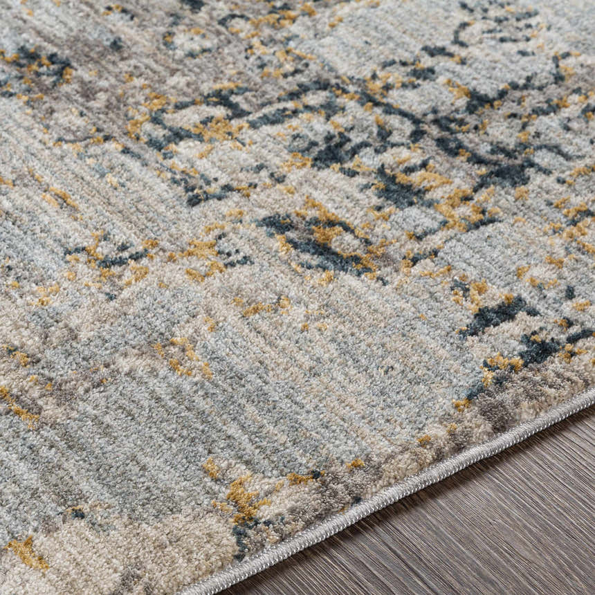 Close-up of the Midfield Luxe Rug showing its charcoal, cream, and gray contemporary pattern and soft, textured polyester material. Texture