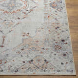 Close-up of the Midtown Washable Area Rug. Features a traditional oriental pattern in brick red, charcoal, gray, and peach. Front