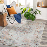 Living room scene with Midtown Washable Area Rug in brick red, charcoal, and gray. Styled with a modern chair and wood accents. Roomscene-Rectangle