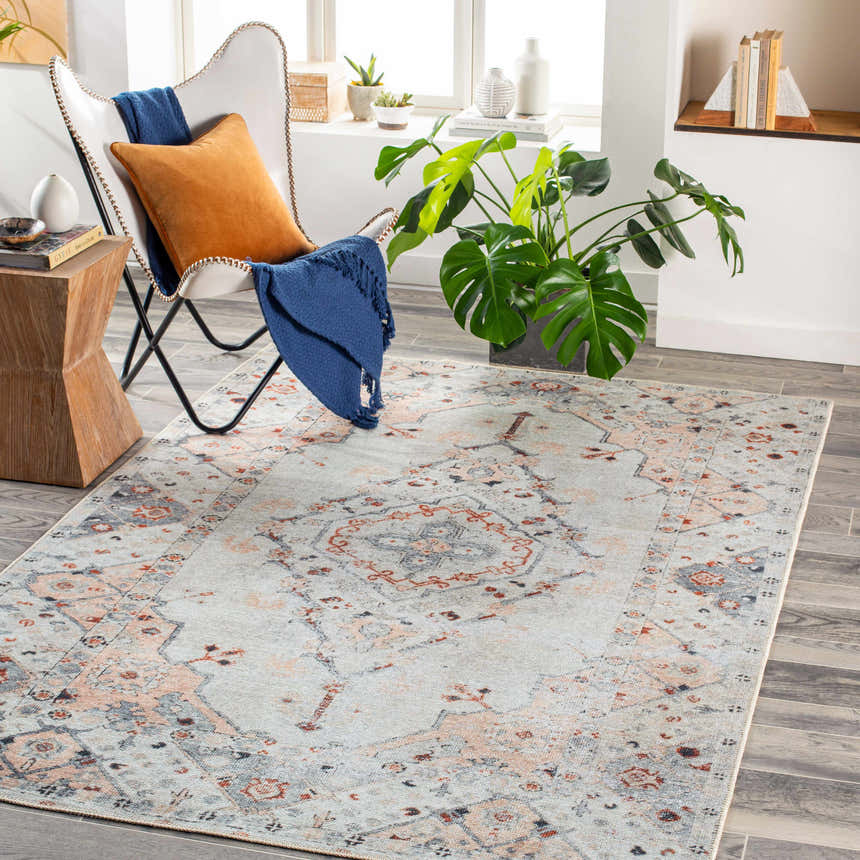 Living room scene with Midtown Washable Area Rug in brick red, charcoal, and gray. Styled with a modern chair and wood accents. Roomscene-Rectangle