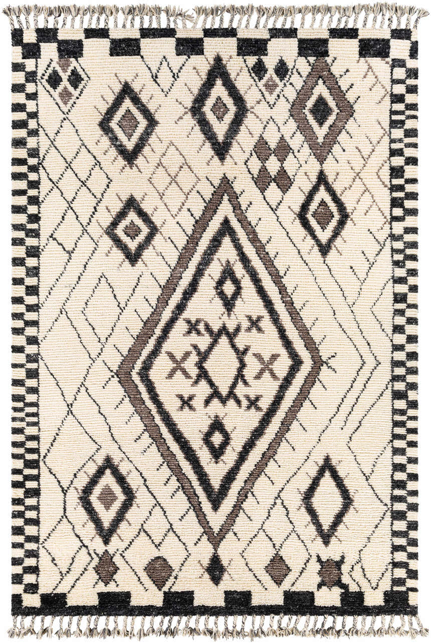 Close-up of the hand-knotted Minyama Area Rug. Bohemian style with black, charcoal, cream, and gray diamond pattern and fringe. Design-Rectangle-69