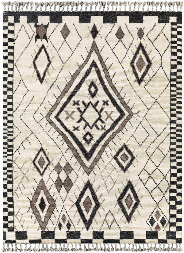 Close-up of the Minyama Area Rug. Hand-knotted wool rug with black, charcoal, cream, and gray geometric diamond pattern and tassels. Design-Rectangle-810