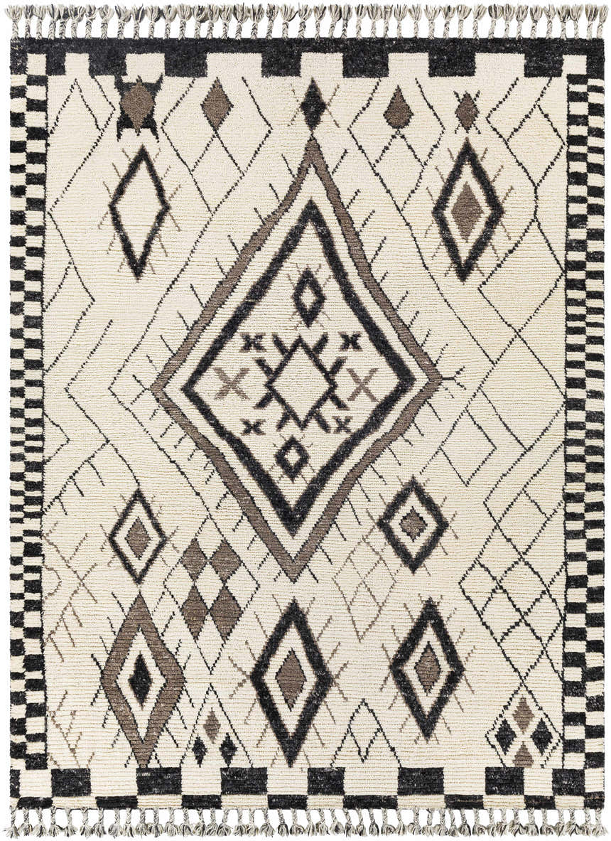 Close-up of the Minyama Area Rug. Hand-knotted wool rug with black, charcoal, cream, and gray geometric diamond pattern and tassels. Design-Rectangle-810