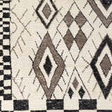 Close-up of the Minyama Area Rug showing its cream base and black and charcoal geometric diamond pattern. Swatch