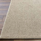 Close-up of the Matah Beige Outdoor Area Rug showing its woven texture and neutral tan and light brown colors. Front