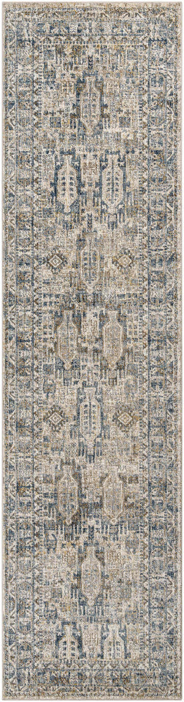 Close-up of the Mundesley Area Rug. Features a traditional, bohemian pattern in cream, dark blue, and brown hues. Design-Runner-2710