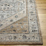 Close-up of the Minal Luxe Thick Area Rug. Farmhouse style rug in dark gray, medium gray, and beige on hardwood floor. Front