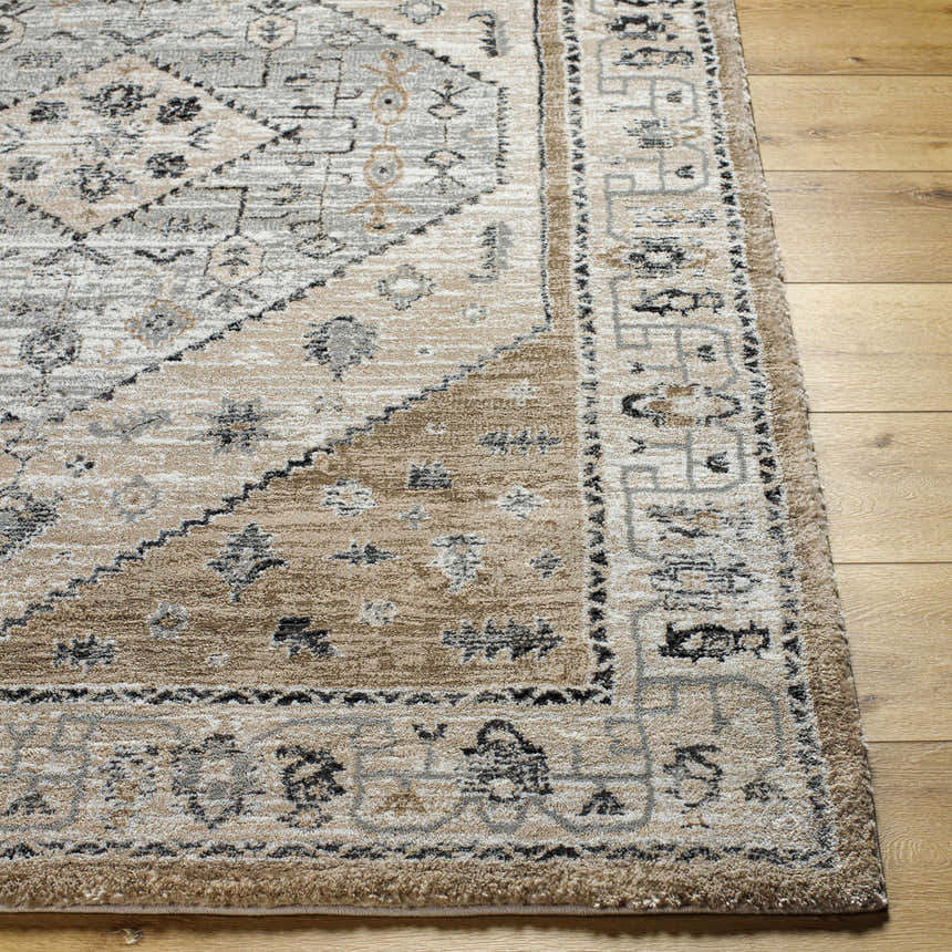 Close-up of the Minal Luxe Thick Area Rug. Farmhouse style rug in dark gray, medium gray, and beige on hardwood floor. Front