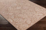 Close-up of a Maninihon 3D Outdoor Area Rug. Clay-colored rug with an off-white floral pattern on dark wood flooring. Corner