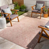 Outdoor patio scene with clay-colored Maninihon 3D Outdoor Area Rug, wood chairs, and potted plants. Roomscene-Rectangle