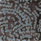 Close-up of the Pensacola Denim/Black rug. Abstract denim blue pattern on a dark charcoal background. Hand-knotted wool and viscose texture. Swatch