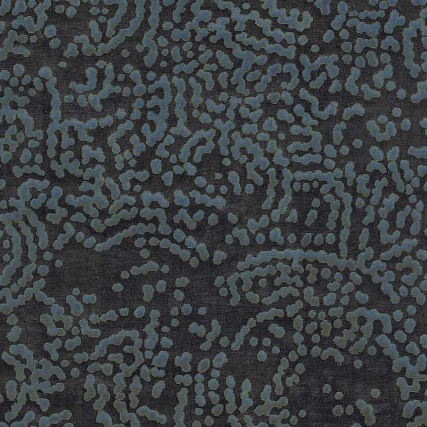 Close-up of the Pensacola Denim/Black rug. Abstract denim blue pattern on a dark charcoal gray background. Hand-knotted wool and viscose. Swatch