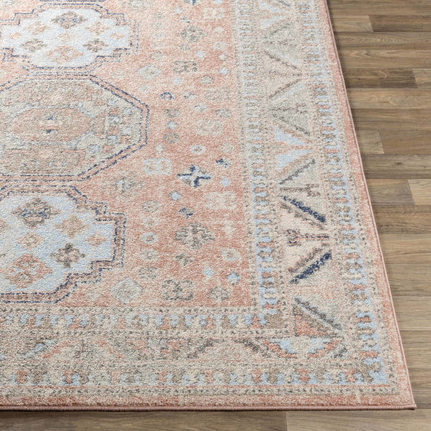 Close-up of the Mantador Area Rug. Features a traditional design in charcoal, ink blue, and light beige. Front