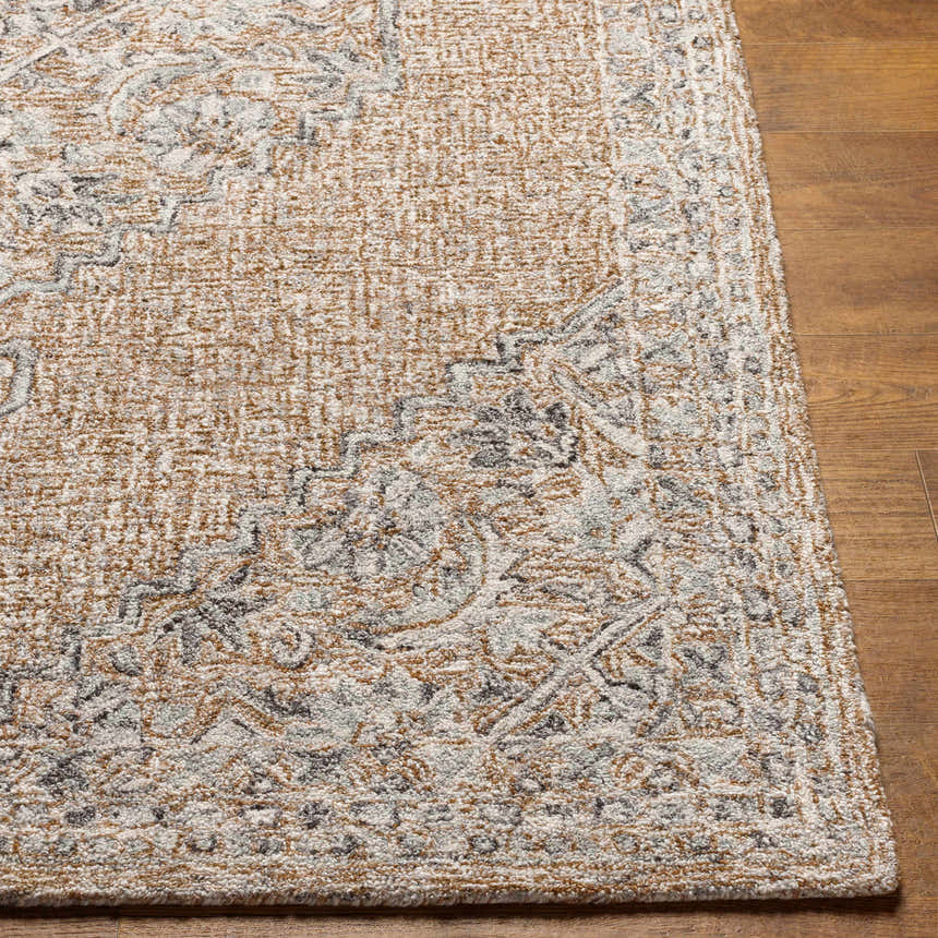 Close-up of the hand-tufted Modimolle Area Carpet. Features a traditional Persian design in brown, camel, and gray tones. Wool and viscose blend. Front
