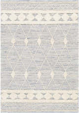 Close-up of the hand woven Moe Area Rug. Features a blue and cream diamond pattern with textured details. Design-Rectangle-576
