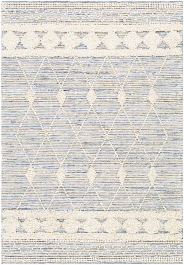 Close-up of the hand woven Moe Area Rug. Features a blue and cream diamond pattern with textured details. Design-Rectangle-576
