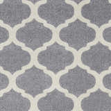 Close-up of the Mongo Carpet featuring a slate gray backdrop and a cream-colored quatrefoil pattern. Swatch
