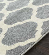 Close-up of the Mongo Carpet in cream and slate, featuring a contemporary geometric pattern and machine-woven texture. Texture
