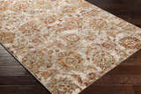 Close-up of the Morinville Area Rug showing its traditional floral pattern in brick red, charcoal, and light beige on dark wood floors. Corner