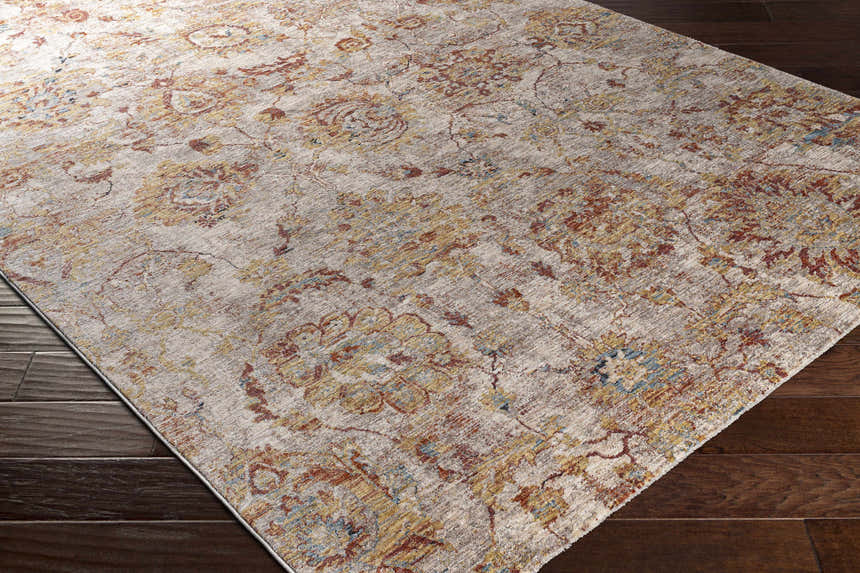 Close-up of the Morinville Area Rug showing its brick red, charcoal, and light beige traditional pattern. Corner