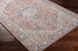 Close-up of the Cream Rust Maribojoc Medallion Washable Area Rug, showcasing its traditional, oriental design and warm color palette. Corner