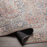 Close-up of the Cream Rust Maribojoc Medallion Washable Area Rug showing its oriental design, rust, cream, and blue colors. Fold