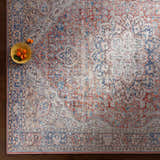 Close-up of a Cream Rust Maribojoc Medallion Washable Area Rug with a traditional oriental pattern in cream, rust, and blue. Styleshot