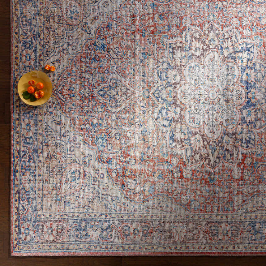 Close-up of a Cream Rust Maribojoc Medallion Washable Area Rug with a traditional oriental pattern in cream, rust, and blue. Styleshot