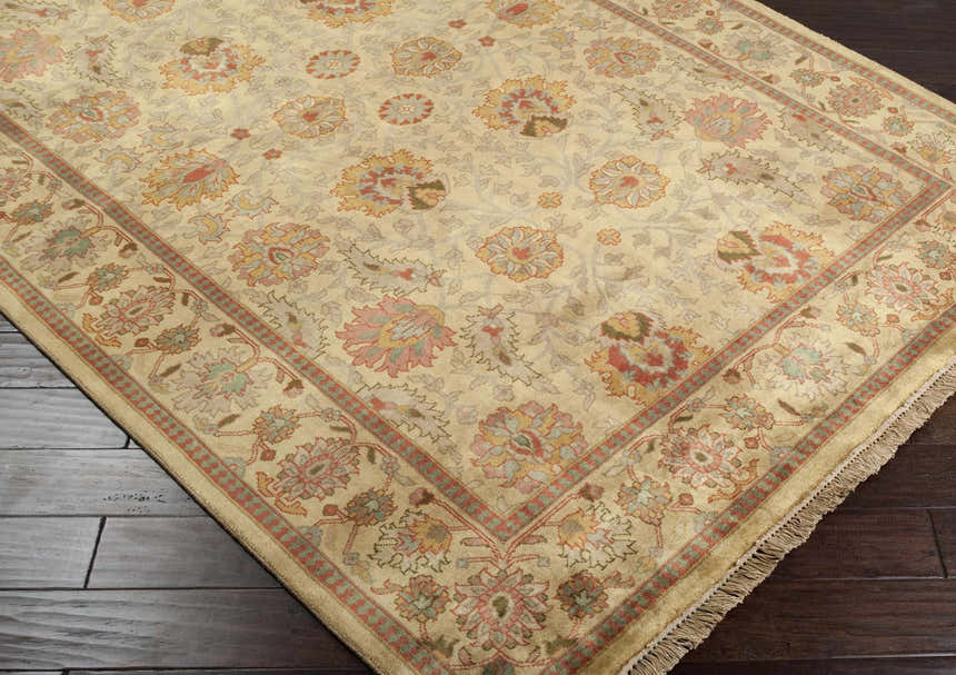 Close-up of the hand-knotted Maurice Area Rug, a traditional design in brick red, brown, and olive floral pattern on a cream background. Corner