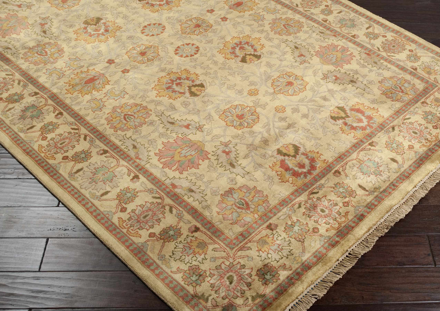 Close-up of the hand-knotted Maurice Area Rug, a traditional design in brick red, brown, and olive floral pattern on a cream background. Corner
